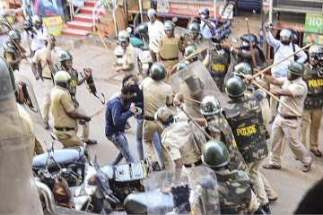 Police personnel baton charge at protestors during a demonstration against the Citizenship Amendment Act (CAA), in Mangaluru, Thursday, Dec.19, 2019.