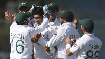 Pakistani players greet Naseem Shah after the dismissal of Sri Lankan batsman during the second Test in Karachi, Pakistan, Sunday