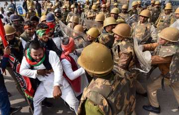 Prayagraj: Police personnel detain Samajwadi Party workers during a protest against Citizenship (Amendment) Act, in Prayagraj (Allahabad)