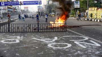 Protestors burn various materials during a demonstration against the passing of Citizenship Amendment Bill in Guwahati