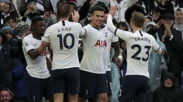 Tottenham's Dele Alli, center, celebrates after scoring his side's second goal during the English Premier League soccer match between Tottenham Hotspur and Brighton & Hove Albion at the Tottenham Hotspur Stadium in London