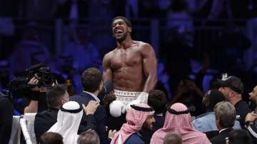 Britain's Anthony Joshua celebrates after beating Andy Ruiz Jr. to win their World Heavyweight Championship contest at the Diriyah Arena, Riyadh