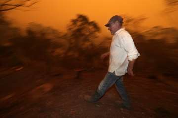 Man burned as huge wildfire forms during Australia crisis