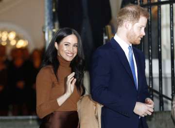 Prince Harry with wife Meghan Markle