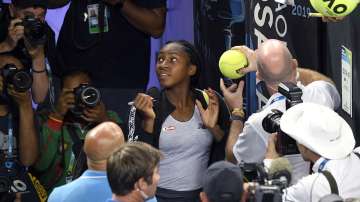 United States' Cori "Coco" Gauff signs autographs after defeating compatriot Venus Williams during their first round singles match at the Australian Open.