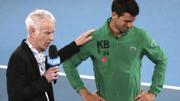 Serbia's Novak Djokovic reacts as he is interviewed by John McEnroe about the death of his friend Kobe Bryant following his quarterfinal win over Canada's Milos Raonic at the Australian Open tennis championship in Melbourne