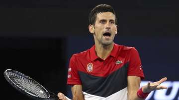 Novak Djokovic of Serbia reacts after being heckled by a spectator during his match against Kevin Anderson of South Africa at the ATP Cup tennis tournament