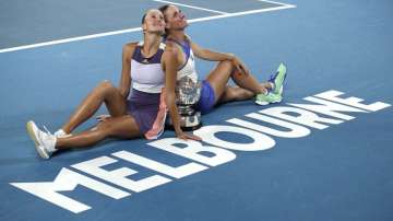 Hungary's Timea Babos, right, and France's Kristina Mladenovic, left, pose for a photo with the Australian Open women's doubles trophy after defeating Taiwan's Hsieh Su-Wei and Barbora Strycova of the Czech Republic at the Australian Open tennis championship in Melbourne, Australia