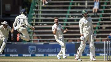 England's bowler Mark Wood, center, reacts after dismissing South Africa's batsman Rassie van der Dussen, right, for 98 runs on day four of the fourth cricket test match between South Africa and England at the Wanderers stadium in Johannesburg