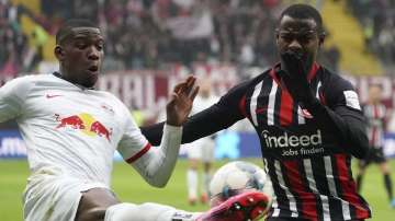 Frankfurt's Evan N'Dicka, right, and Leipzig's Nordi Mukiele fight for the ball during a German Bundesliga soccer match between Eintracht Frankfurt and RB Leipzig in Frankfurt