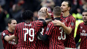 AC Milan's Ante Rebic, center, celebrates with his teammates after scoring his side's third goal during a Serie A soccer match between AC Milan and Udinese