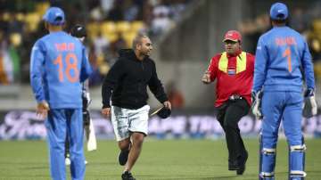 A pitch invader attempts to evade a security guard during game four of the Twenty20 series between New Zealand and India at Sky Stadium on January 31, 2020 in Wellington