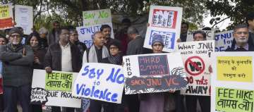 JNU teachers stage a protest over Sunday's violence, in New Delhi