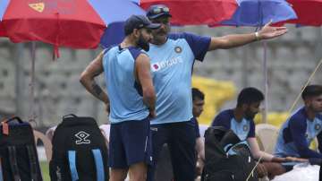 India's cricket coach Ravi Shastri, right, chats with Virat Kohli during a training session ahead of their first one-day international cricket match against Australia in Mumbai