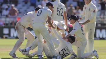 The England team celebrate the wicket of Anrich Nortje during day five of the second cricket test between South Africa and England at the Newlands Cricket Stadium in Cape Town