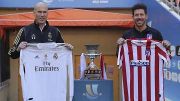 Atletico Madrid's head coach Diego Simone, right, stands with Real Madrid's head coach Zinedine Zidane during the trophy photo call at King Abdullah stadium
