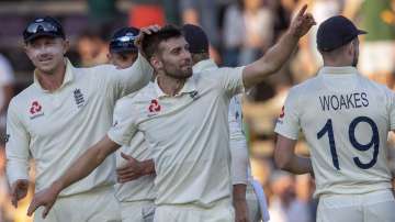 England's bowler Mark Wood, middle, celebrates with teammates after dismissing South Africa's batsman Anrich Nortje on day two of the fourth cricket test match between South Africa and England at the Wanderers stadium in Johannesburg