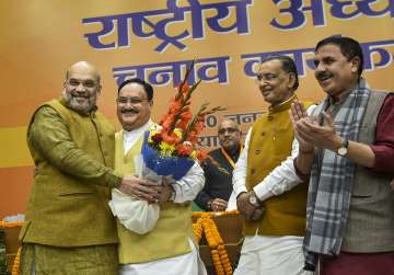 Union Home Minister and outgoing BJP President Amit Shah claps as Organisation Poll process incharge Radha Mohan Singh (2nd R) hands over the victory certificate to party leader J P Nadda (2nd R) after he was elected as the next national President of the party, in New Delhi, Monday, Jan 20, 2020.
?