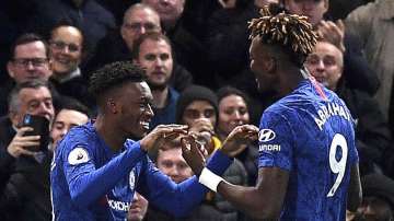 Chelsea's Callum Hudson-Odoi, left, celebrates scoring his side's third goal of the game with teammate Tammy Abraham, during the English Premier League soccer match