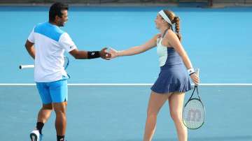 Jelena Ostapenko of Latvia and Leander Paes of India celebrate a point in their Mixed Doubles first round match agains Storm Sanders and Marc Polmans of Australia on day seven of the 2020 Australian Open at Melbourne Park on January 26, 2020 in Melbourne, Australia