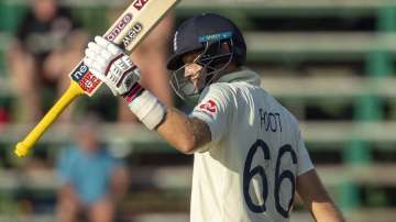 England's captain Joe Root salutes the crowd after reaching his half century on day three of the fourth cricket test match between South Africa and England at the Wanderers stadium in Johannesburg