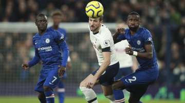 Tottenham's Harry Kane and Chelsea's Antonio Rudiger, right, eye the ball during the English Premier League soccer match between Tottenham Hotspur and Chelsea, at the Tottenham Hotspur Stadium in London, Sunday, Dec. 22