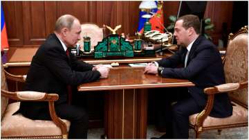 Russian President Vladimir Putin, left, listens to Russian Prime Minister Dmitry Medvedev during their meeting in the Kremlin in Moscow, Russia