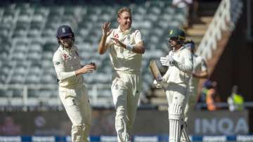 England's bowler Stuart Broad, center, celebrates with teammates Ollie Pope, left, after dismissing South Africa's batsman Dwaine Pretorius on day four of the fourth cricket test match between South Africa and England at the Wanderers stadium in Johannesburg