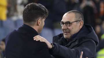 Roma's head coach Paulo Fonseca, left, and Juventus' coach Maurizio Sarri greet prior to the Serie A soccer match between Roma and Juventus at the Rome Olympic Stadium