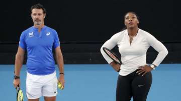 United States' Serena Williams and her coach Patrick Mouratoglou react during a practice session ahead of the Australian Open tennis championship in Melbourne