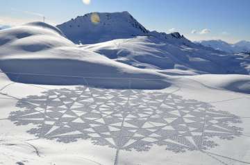 Artist uses snow as canvas for massive geometrical designs