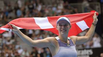 Denmark's Caroline Wozniacki unfurls Denmark's flag after her third round loss to Tunisia's Ons Jabeur at the Australian Open tennis championship in Melbourne
