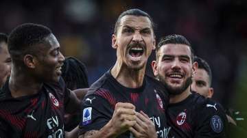 Milan's Zlatan Ibrahimovic celebrates with teammates after scoring his side's second goal during an Italian Serie A soccer match between Cagliari and Milan in Cagliari