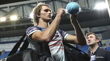 Germany's Alexander Zverev signs autographs after defeating Italy's Marco Cecchinato in their first round singles match at the Australian Open tennis championship in Melbourne