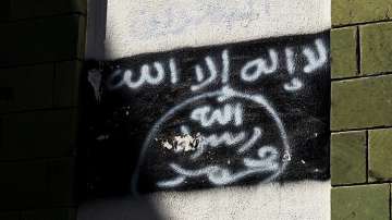 The black al-Qaida flag is sprayed on the wall of a damaged school that was turned into a religious 