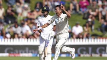 Trent Boult of New Zealand celebrates after taking the wicket of Cheteshwar Pujara of India during day three of the First Test match between New Zealand and India at Basin Reserve on February 23