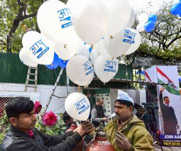  
Aam Aadmi Party workers celebrate ahead of the final results, as early trends show party's victory in the Delhi Assembly polls, at party headquarters in New Delhi, Tuesday