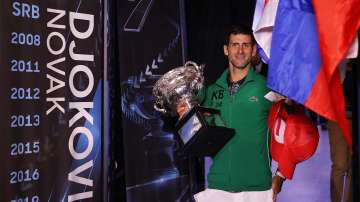 Novak Djokovic of Serbia walks onto Margaret Court Arena holding the Norman Brookes Challenge Cup after winning the Men's Singles Final against Dominic Thiem of Austria on day fourteen of the 2020 Australian Open at Melbourne Park on February 02