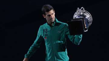Serbia's Novak Djokovic carries the Norman Brookes Challenge Cup around Rod Laver Arena after defeating Austria's Dominic Thiem in the men's singles final of the Australian Open tennis championship in Melbourne