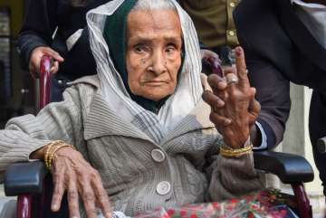 111-year-old Kalitara Mandal shows her finger marked with indelible ink after casting vote during th