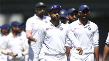 Virat Kohli of India leads his team off the field at the conclusion of day four of the First Test match between New Zealand and India at Basin Reserve on February 24