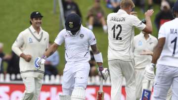 India's Virat Kohli, second left, walks from the field after he was dismissed by New Zealand's Kyle Jamieson, 12, after being dismissed for 8 runs during the first cricket test between India and New Zealand at the Basin Reserve in Wellington