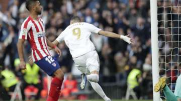 Real Madrid's Karim Benzema celebrates after scoring his side's first goal during a Spanish La Liga soccer match between Real Madrid and Atletico Madrid at the Santiago Bernabeu stadium in Madrid