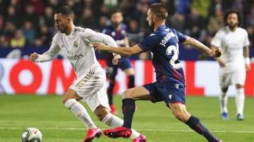 Real Madrid's Eden Hazard, left, and Levante's Jorge Miramon challenge for the ball during the Spanish La Liga soccer match between Levante and Real Madrid at the Ciutat de Valencia stadium in Valencia, Spain, Saturday, Feb.22