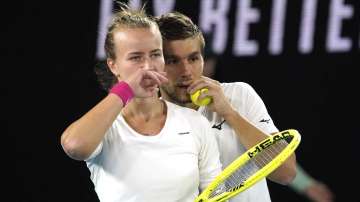 Barbora Krejcikova, left, of the Czech Republic and Croatia's Nikola Mektic talk during their match against Bethanie Mattek-Sands of the U.S. and partner Britain's Jamie Murray in the mixed doubles final at the Australian Open tennis championship in Melbourne
