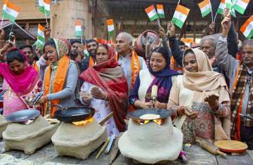 Women Shiv Sena members make 'chapatis' on clay chulhas (ovens) during a unique protest against the 