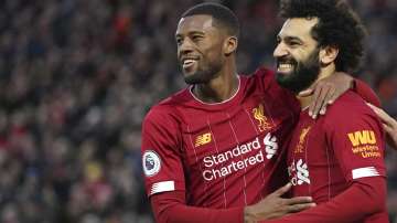 Liverpool's Mohamed Salah, right, celebrates with Liverpool's Georginio Wijnaldum after scoring his sides third goal during the English Premier League soccer match between Liverpool and Southampton at Anfield Stadium