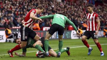 Sheffield United's Sander Berge, left, and Brighton and Hove Albion's Lewis Dunk during their cane against Sheffield, during their English Premier League soccer match at Bramall Lane in Sheffield, England, Saturday Feb. 22