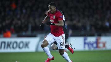 Manchester United's Anthony Martial, front, vies for the ball with Brugge's Brandon Mechele to score his side first goal during an Europa League round of 32 first leg soccer match between Brugge and Manchester United at the Jan Breydel stadium in Bruges, Belgium, Thursday, Feb. 20