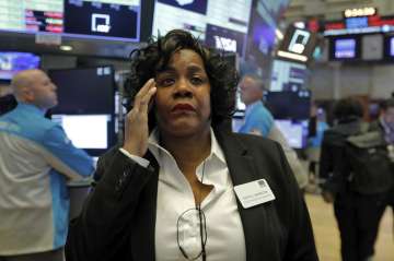 Yvette Arrington, with the New York Stock Exchange Trading Floor Operations, works on the floor of t